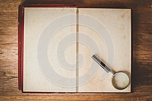 Magnifying glass and old books