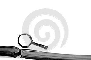 Magnifying glass on old empty book pages isolated on white background