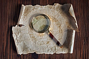 Magnifying glass and old parchment