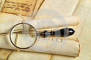 Magnifying glass with old sheets