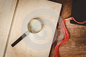 Magnifying glass on open old book blank