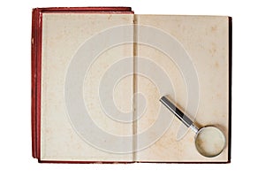 Magnifying glass and opened old book