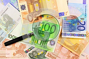 Magnifying glass over Euros. Euro paper notes