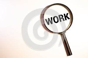 Magnifying glass over the word job wooden letters on yellow background. Top view, flat lay