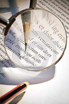 Magnifying glass and pen photo