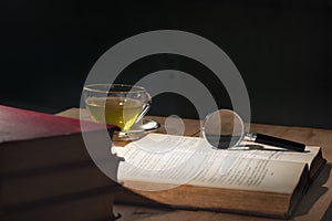 Magnifying glass on open old book