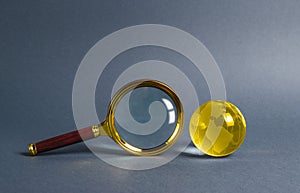 Magnifying glass and planet earth glass ball. Concept of global search and globalization process. International business