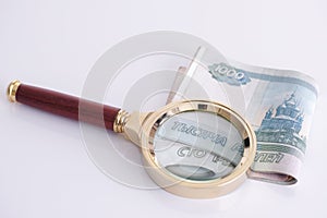 Magnifying glass and russian money