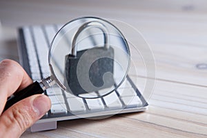 Magnifying glass search open or password on laptop