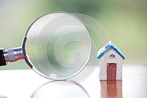 Magnifying glass searching for a new home, Loan for real estate or save money for buy a house to family in the future concept