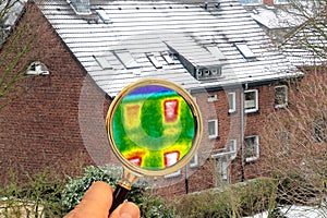 Magnifying glass shows thermal image on a non-insulated house