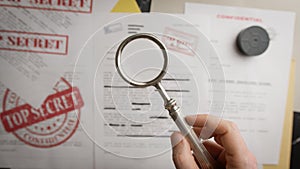Magnifying glass shows very confidential and personal documents
