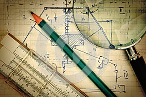 magnifying glass and a slide rule on the old page