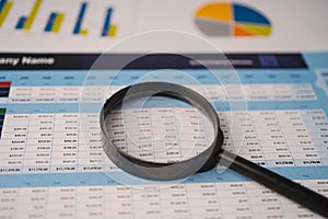Magnifying glass on spreadsheet charts graphs paper. Financial development, Banking Account, Statistics, Investment Analytic