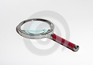 Magnifying glass tool for research and scrutiny. Transparent glass lens for detailed analysis.