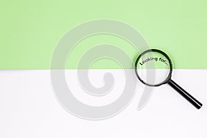 Magnifying glass on a white-green background. Top view