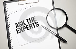 Magnifying glass with the word Ask the Expert on white background