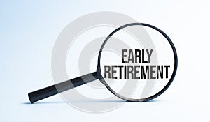 Magnifying glass with the word EARLY RETIREMENT. Business concept