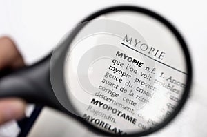 Magnifying glass on the word myopie (myopia) photo