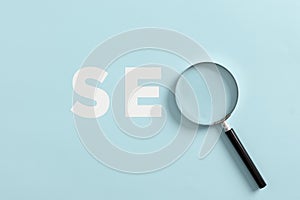 Magnifying glass with the word SEO search engine optimization