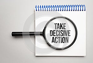 Magnifying glass with the word TAKE DECISIVE ACTION on chart background