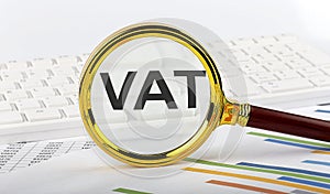 Magnifying glass with the word VAT on the chart background