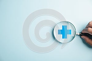 magnifying glass work on plus symbol and healthcare icon