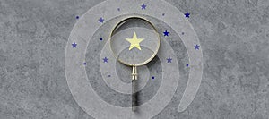 Magnifying glass with a yellow star mark as symbol for finding a solution  - 3d illustration