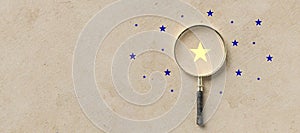 Magnifying glass with a yellow star mark as symbol for finding a solution - 3d illustration