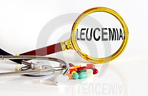 Magnifying lens with text LEUCEMIA with medical tools photo