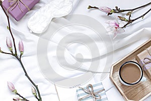 Magnolia flower flat lay morning in bed concept composition.
