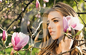 Magnolia. Spring girl in blooming garden. Summer girl and sensual moment. Beauty woman outdoors in blooming trees
