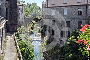 Magra River with the ancient bridge between the houses of Bagnone, a beautiful ancient town in Tuscany, Italy photo