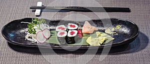 maguro tuna sushi served on a bamboo leaf, with radishes and daikons julienne, ginger gari and horseradish wasabi, japanese food