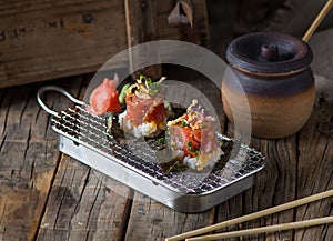 MAGURO ZUKE taco maki served in a dish isolated on wooden background side view of taco maki