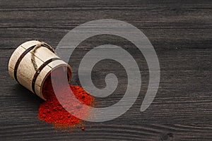 Magyar Hungarian brilliant red sweet paprika powder. Traditional seasoning for cooking national food. Wooden keg, black wooden