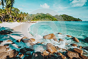 Mahe, Seychelles. Beautiful Anse intendance, tropical beach with ocean wave rolling towards sandy beach. Coconut palm