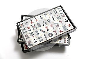 Mahjong game tiles in box on white background