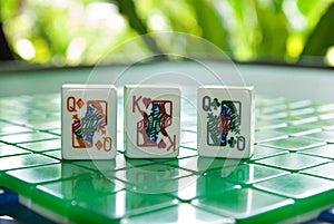 Mahjong tiles of the King of hearts with two queens