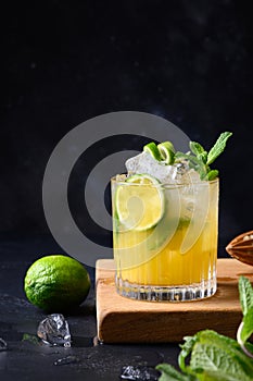 Mai Tai Classic rum cocktail. Tropical lemonade with lime on black. Vertical format