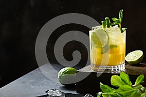 Mai Tai Cocktail. Classic rum tropical cocktail with lime arnish mint on black. Copy space