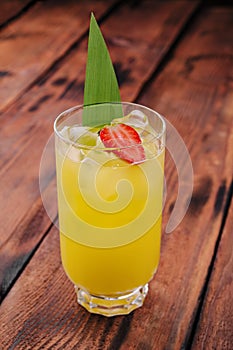 mai tai cocktail with pineapple and rum with a piece of strawberry