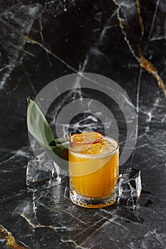 Mai Tai trendy alcoholic cocktail with rum, liqueur, syrup, lime juice, mint and crushed ice. Dark background, copy