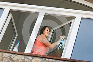 Maid cleaning windows