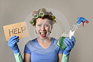 Maid cleaning woman or lazy housewife in stress in rollers with spray bottle asking for help