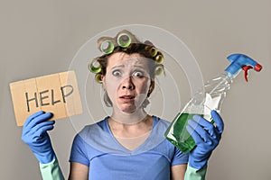 Maid cleaning woman or lazy housewife in stress in rollers with spray bottle asking for help