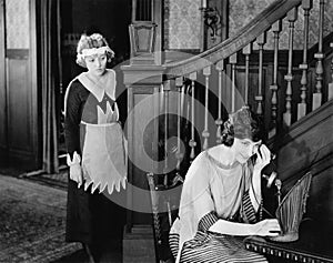 Maid eavesdropping on womans telephone call photo