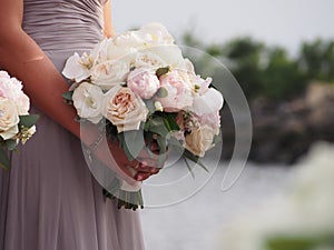 Maid of honor holding Brides bouquet