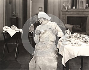 Maid joined by a fine feathered friend for breakfast