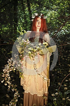 Maiden of the forest with book full of flowers